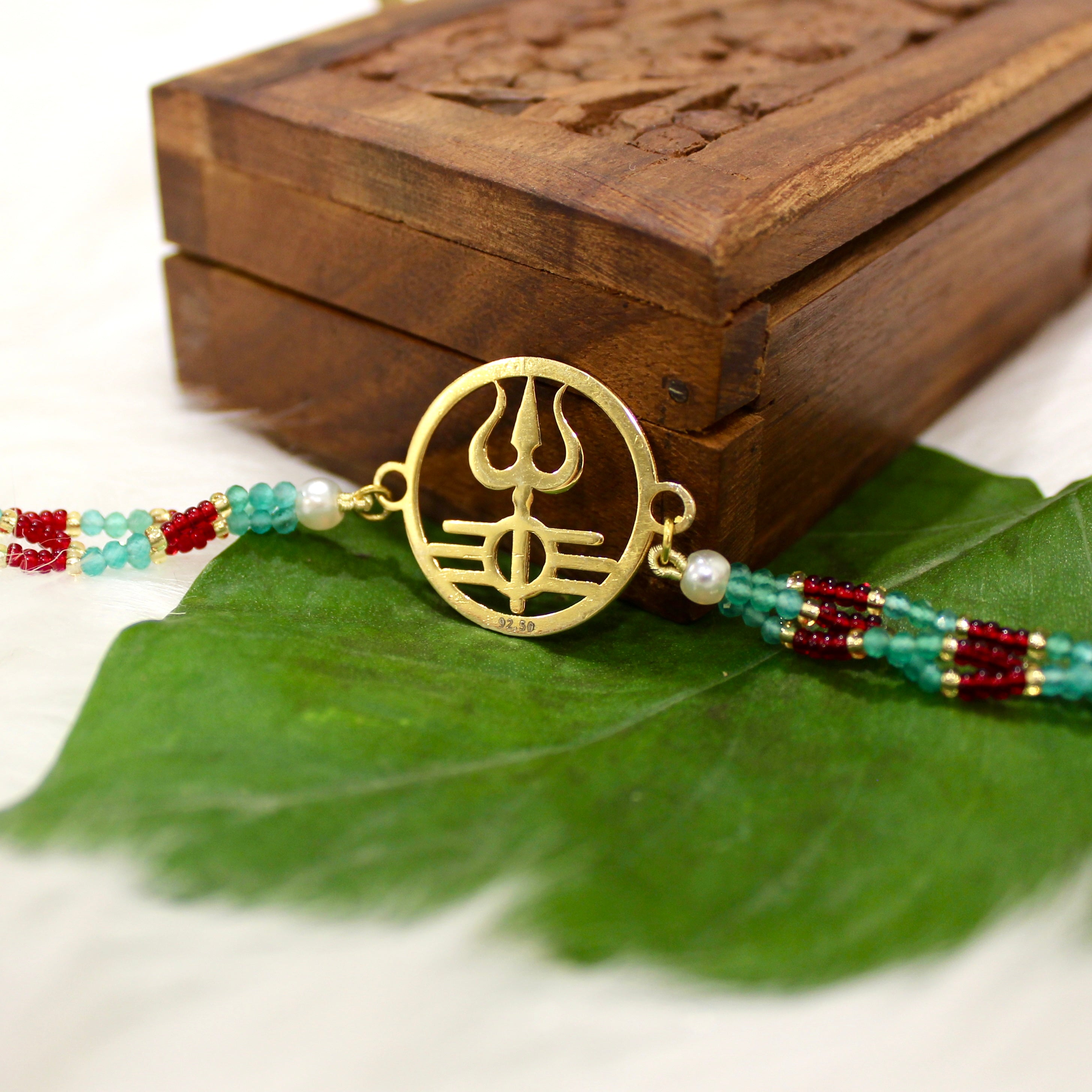 Trishul In Circle Gold Polish Maroon Thread Rakhi In 925 Silver