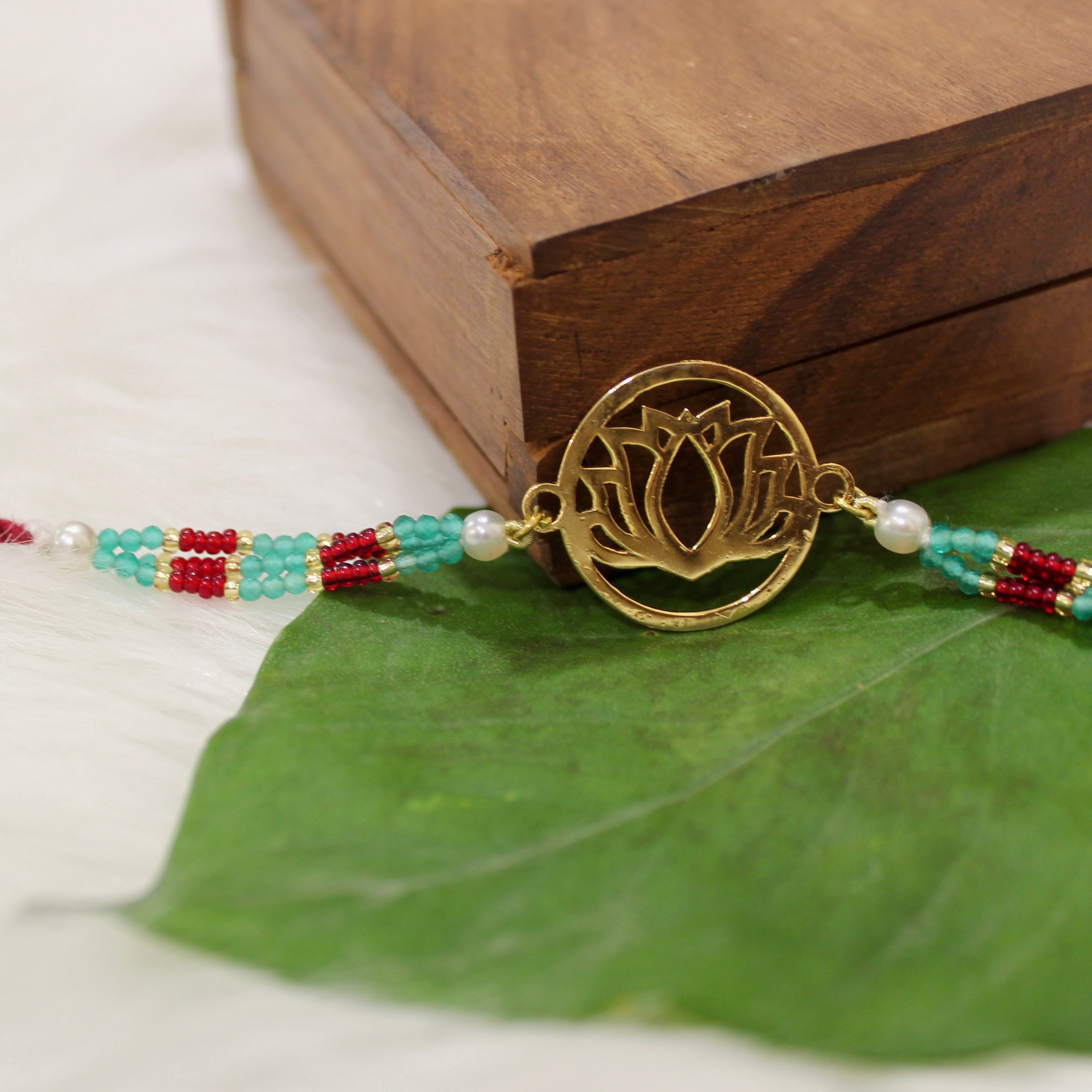 Lotus In Gold Polish Maroon Thread Rakhi In 925 Silver