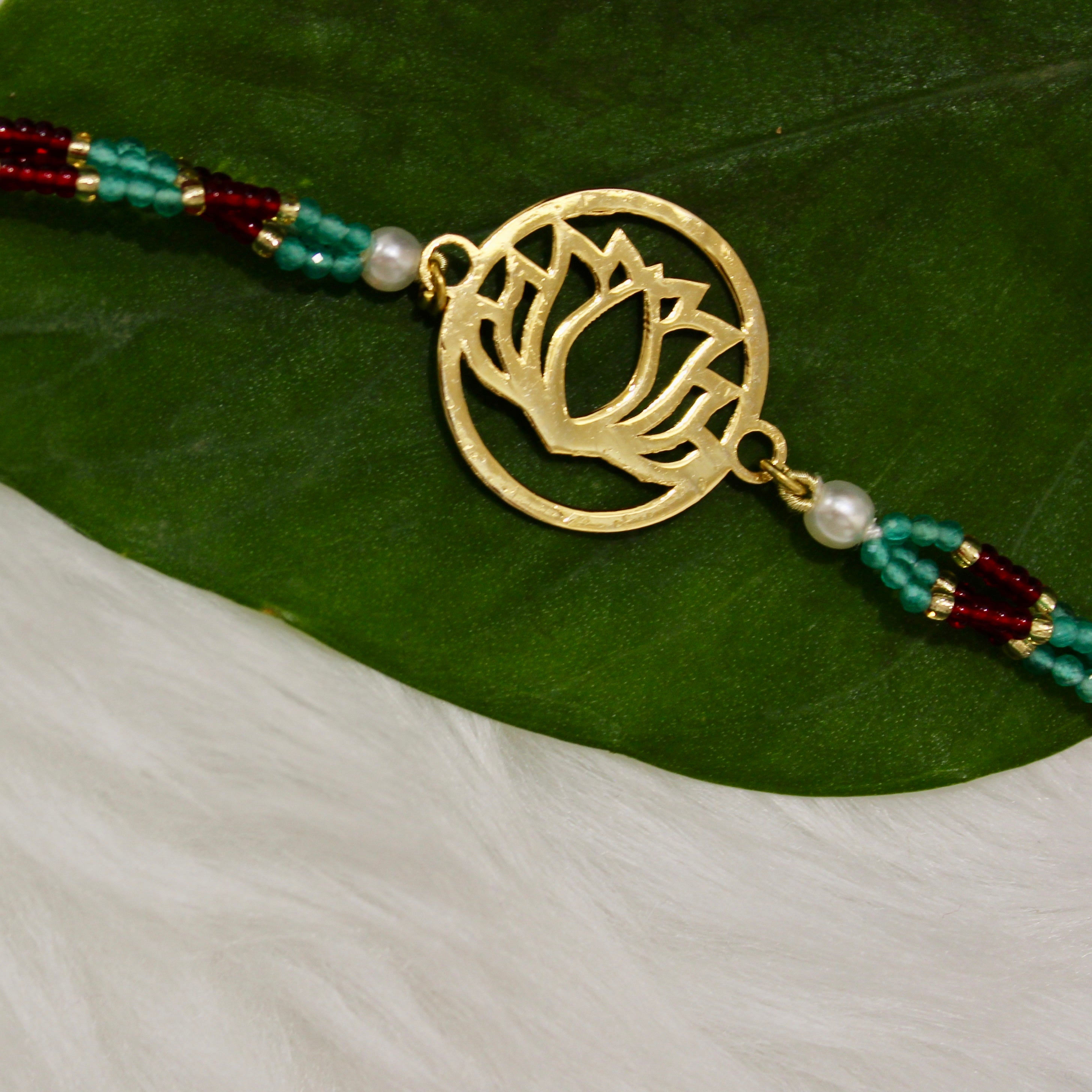 Lotus In Gold Polish Maroon Thread Rakhi In 925 Silver