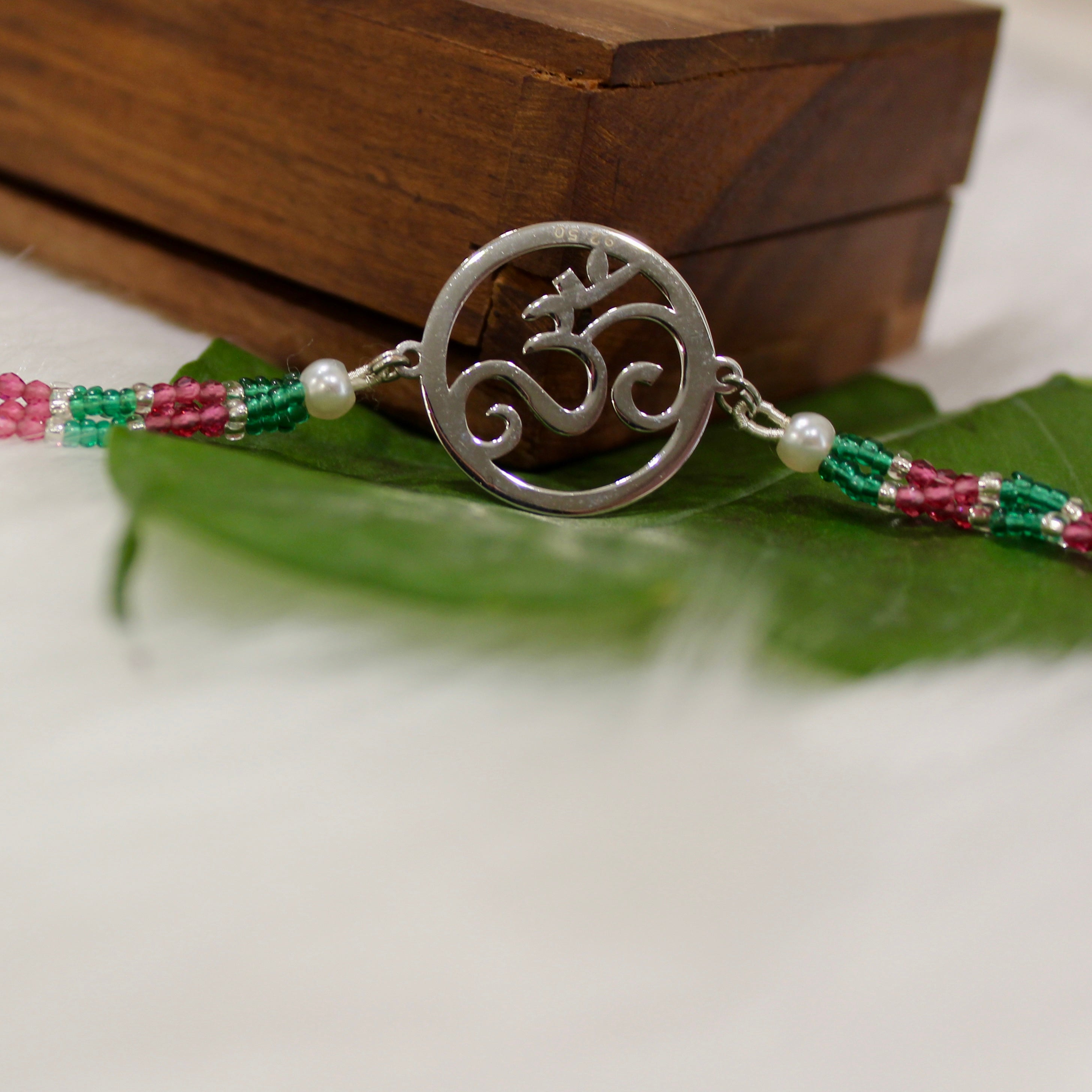 Om In Circle Pink Thread Rakhi In 925 Silver