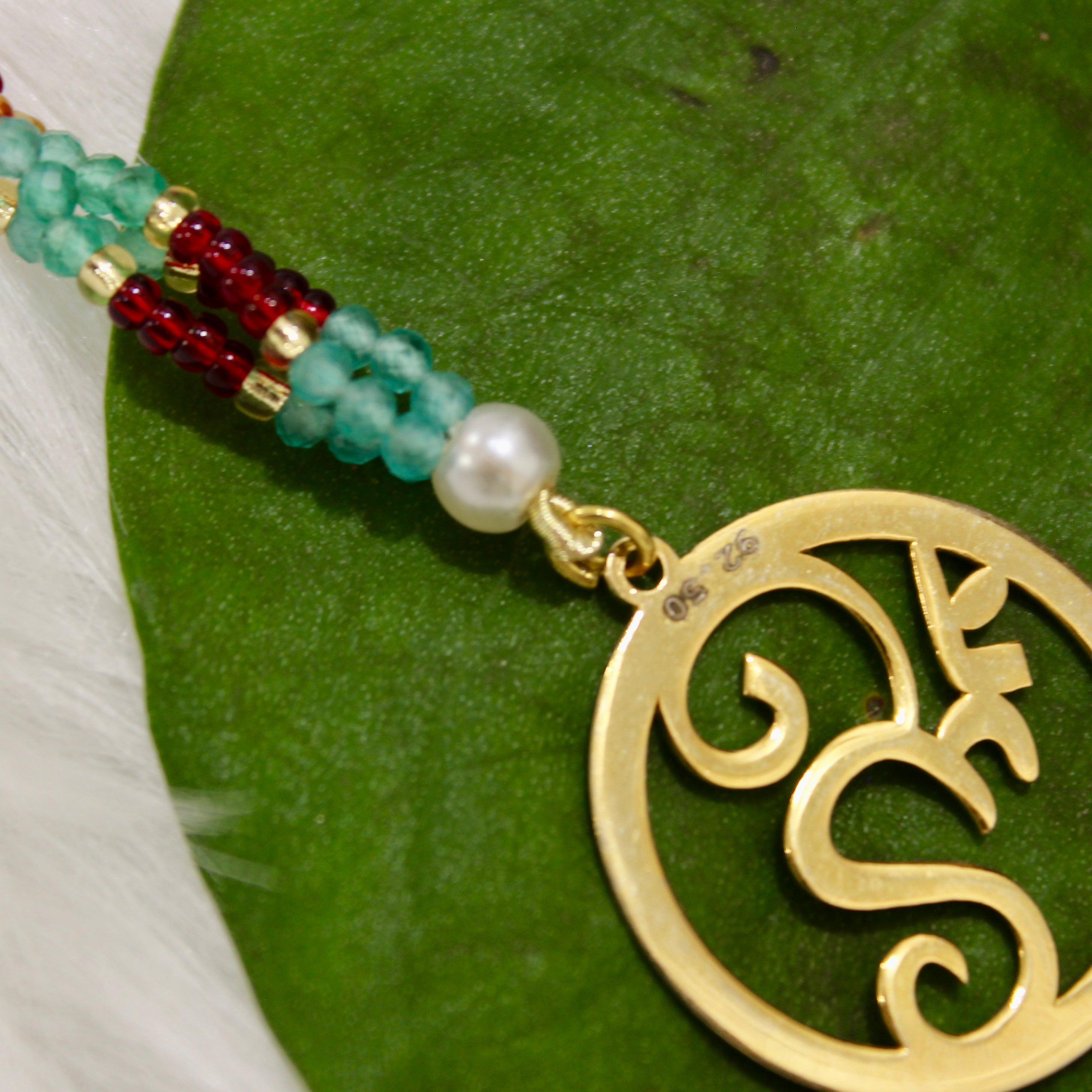 Om In Circle Gold Polish Maroon Thread Rakhi In 925 Silver