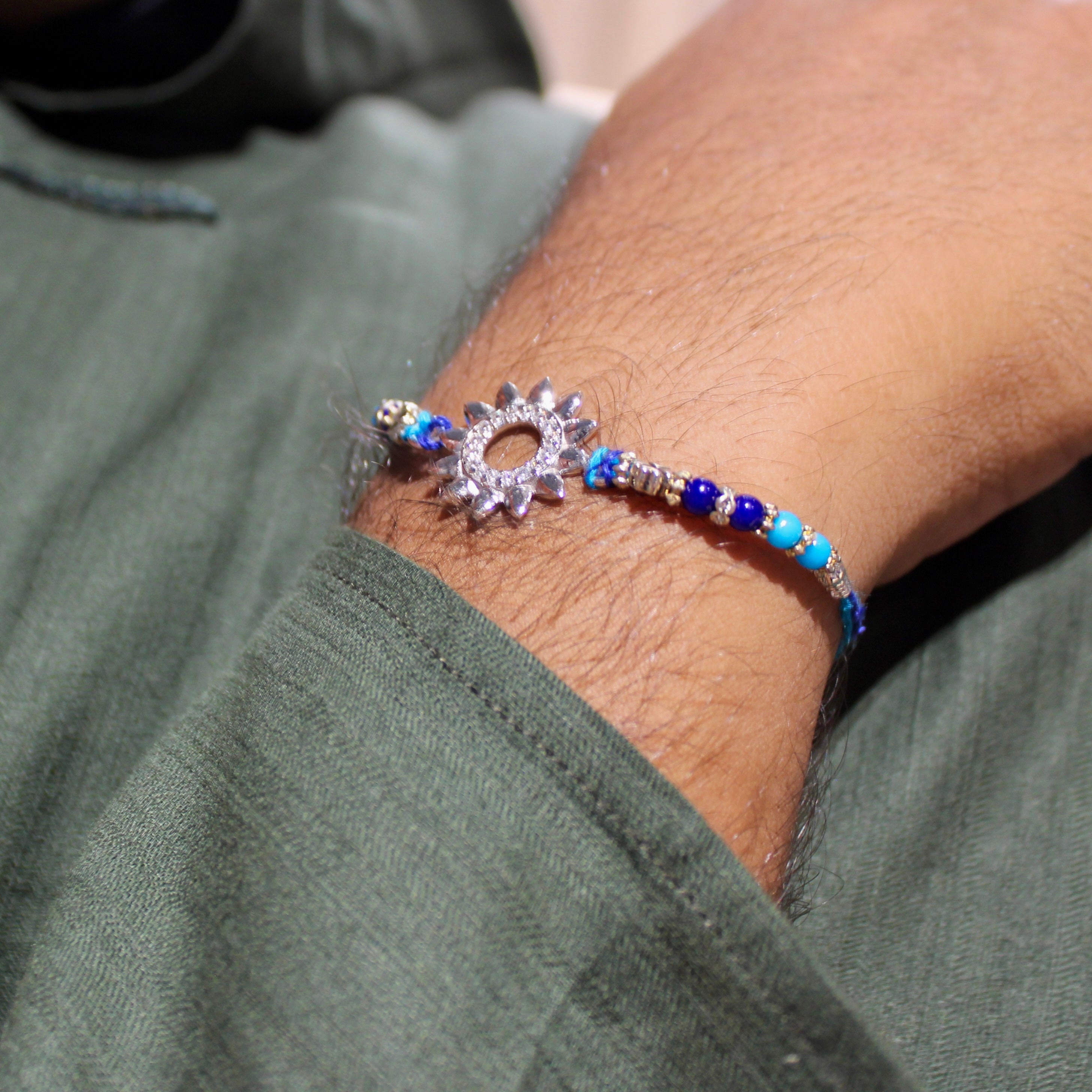 Sun Charm Blue Thread Rakhi In 925 Silver