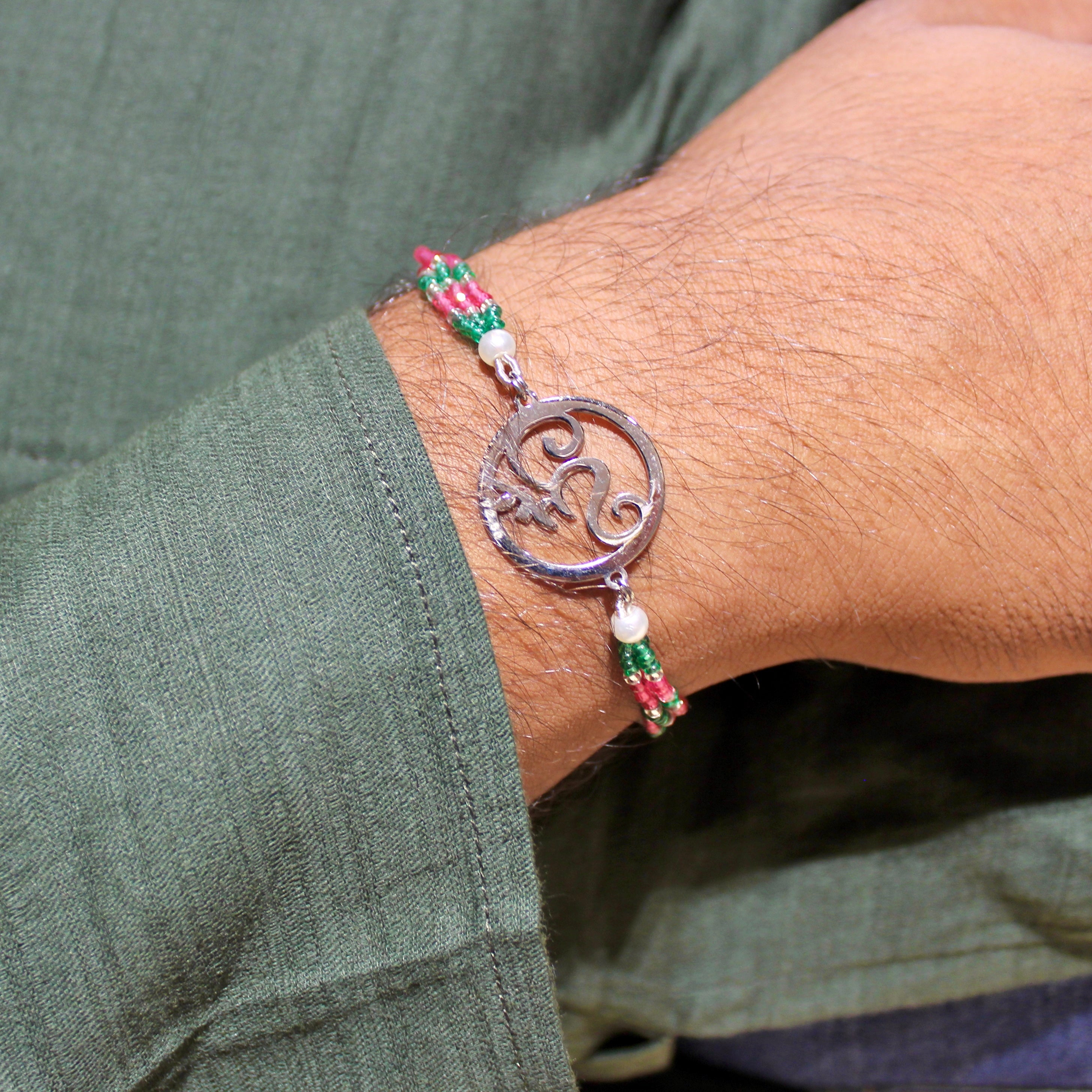 Om In Circle Pink Thread Rakhi In 925 Silver