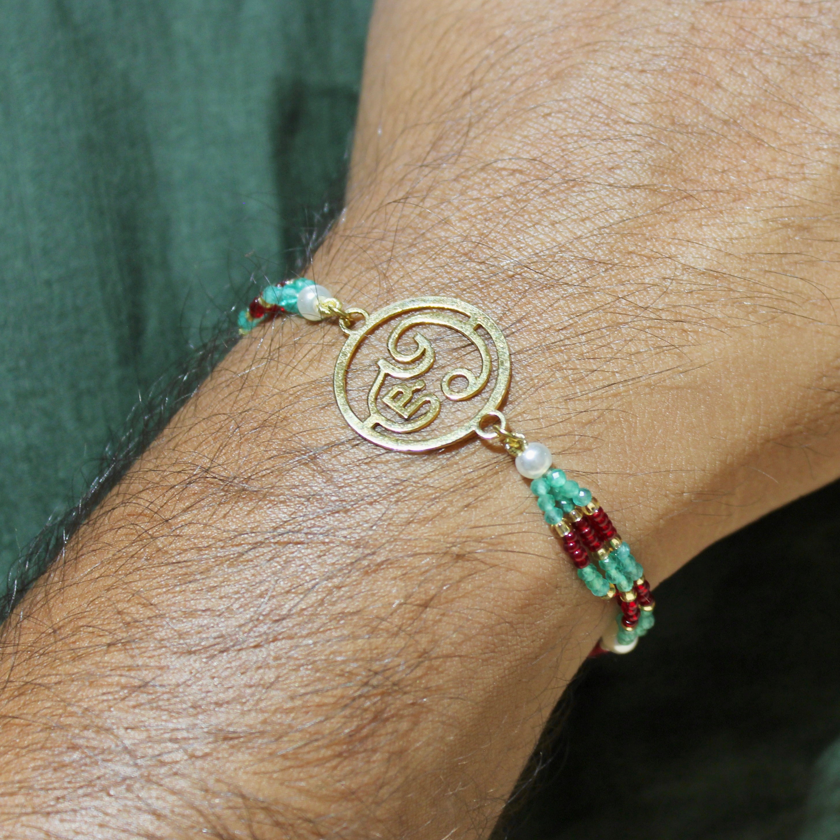 Ganesha In Gold Polish Maroon Thread Rakhi in 925 Silver
