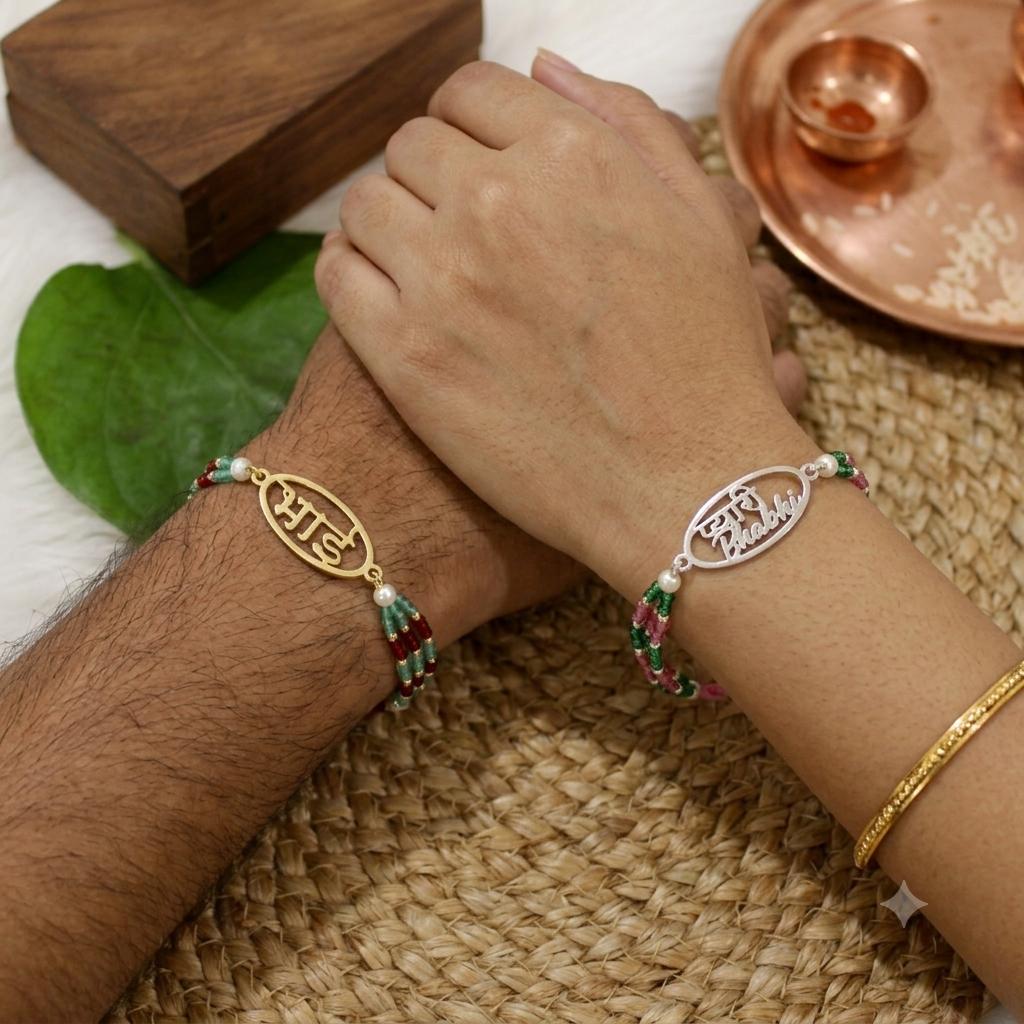 Two personalized name bracelets with Tibetan silver and gold charms worn on a person's wrists, resting on a woven mat with traditional decorative props.