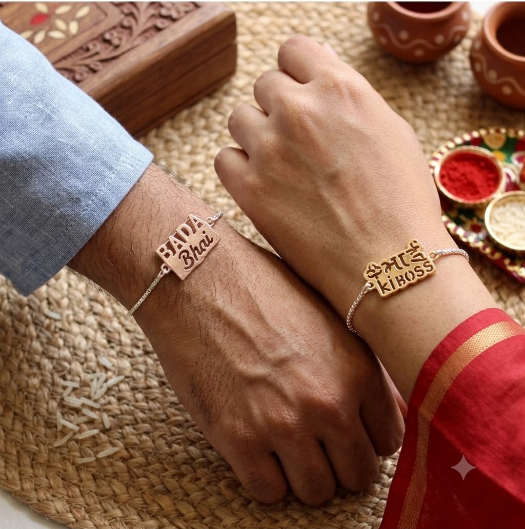 Two matching silver-toned bracelets worn on wrists, each engraved with Devanagari text and a small heart. One bracelet reads 'Saiya Bhai' and the other 'Bhaiya Ko Dosti'.